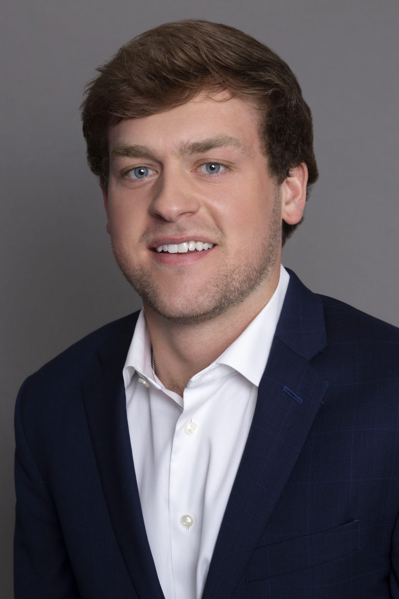 Thomas Fatjo headshot - wearing a suit jacket and a white dress shirt